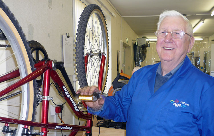 Older man fixing a bike
